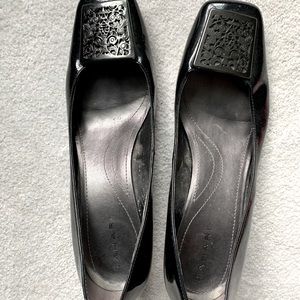 Black Tahari heels with ornate silver toe buckle
